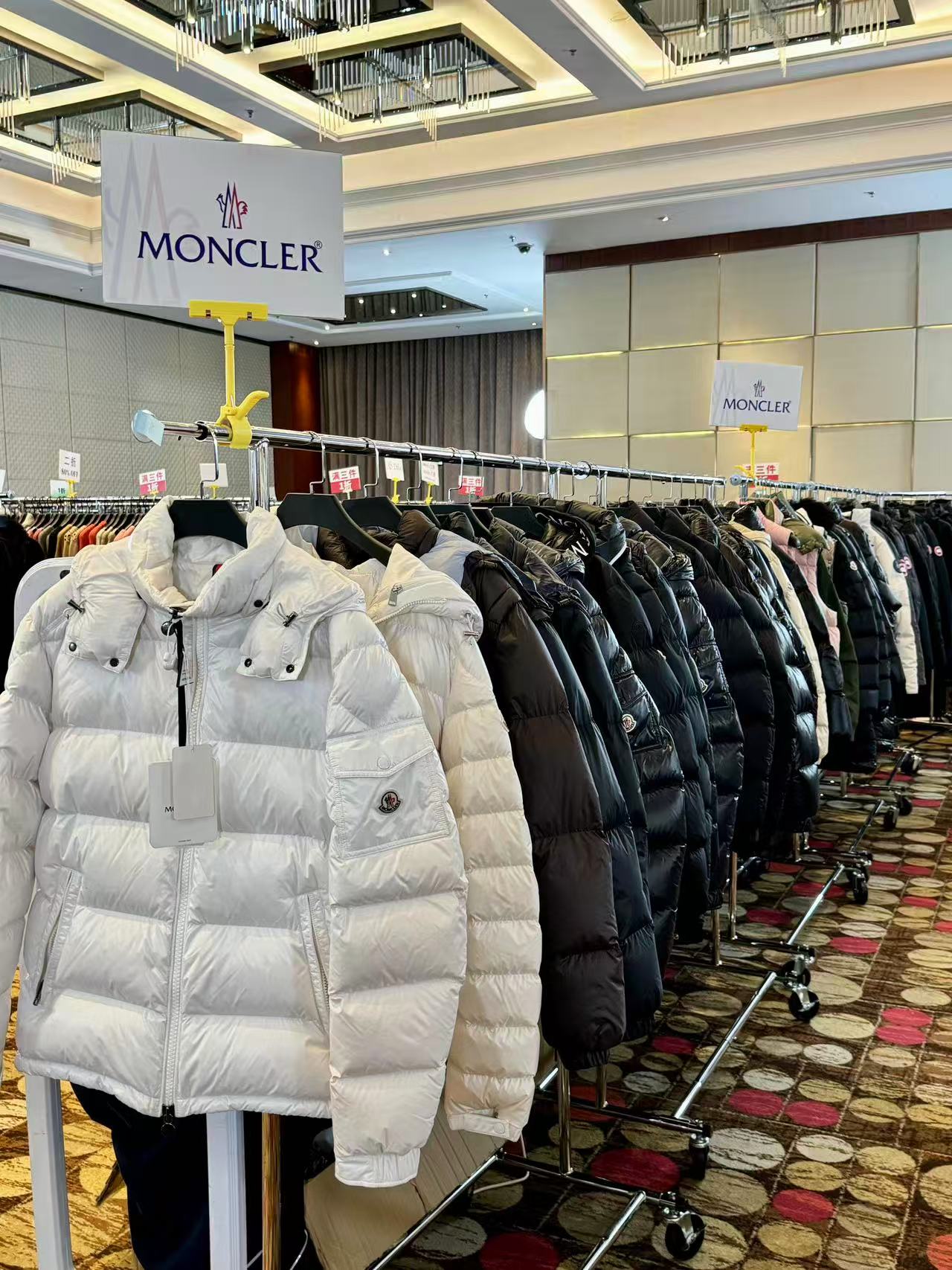 Down jackets displayed on a clothing rack
